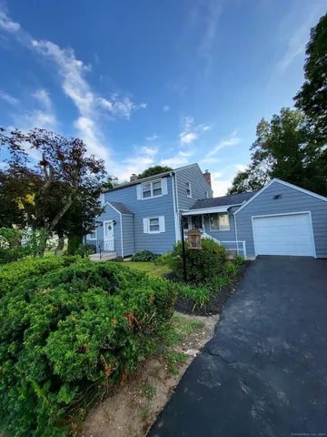 a view of a house with a yard and tree s