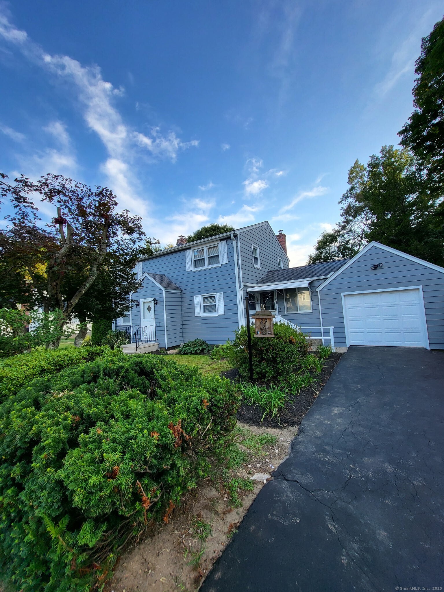 a view of a house with a yard and tree s