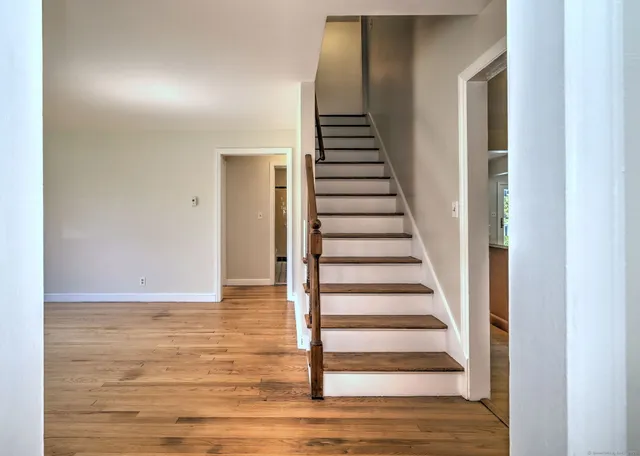 a view of an entryway with wooden floor
