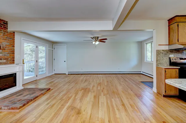 wooden floor in an empty room with a fireplace