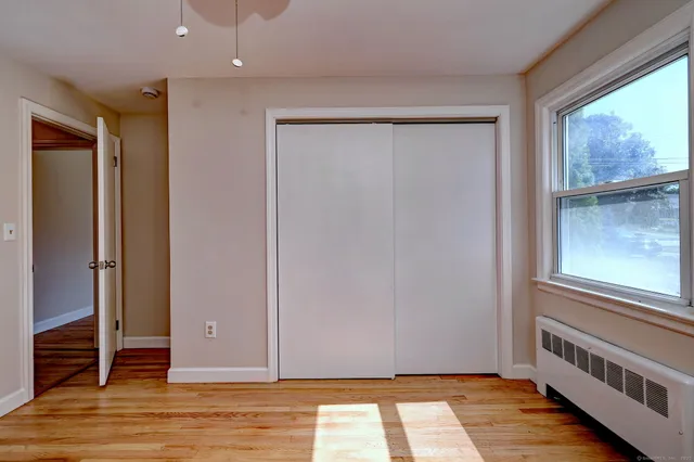 a view of a room with wooden floor and windows