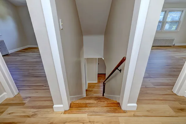 a view of entryway and hall with wooden floor