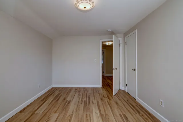 a view of a room with wooden floor