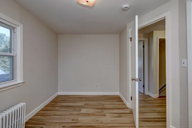 a view of a room with wooden floor and staircase