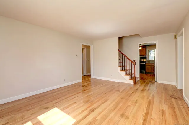 a view of a room with wooden floor and stairs