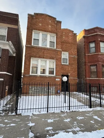 a front view of a house with a iron gate