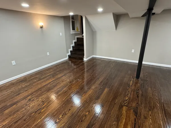 a view of an empty room with wooden floor