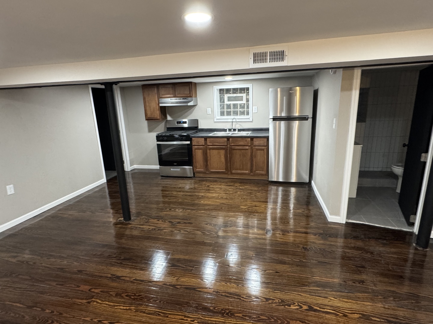 6840 South Champlain Avenue, Unit G Chicago, IL 60637 - Photo 7 of 11 a kitchen with granite countertop a refrigerator stove and wooden floor