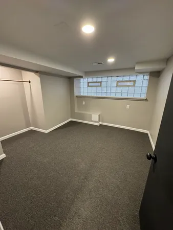 an empty room with a empty space and windows
