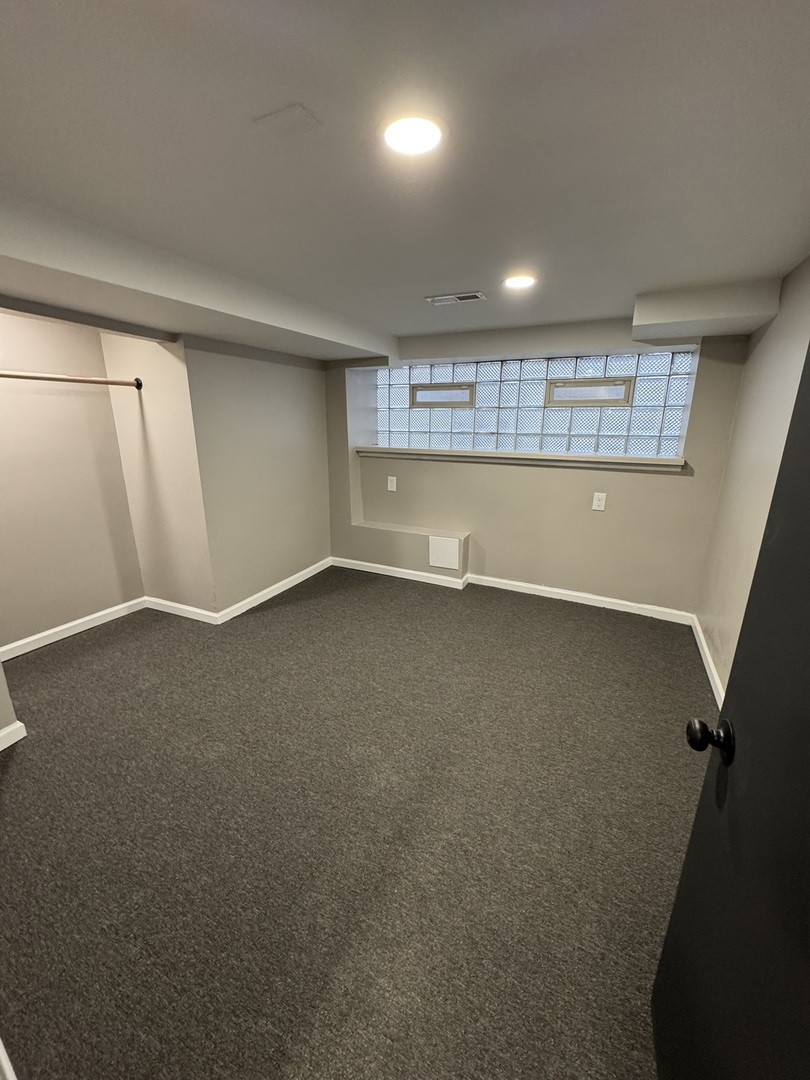 6840 South Champlain Avenue, Unit G Chicago, IL 60637 - Photo 8 of 11 an empty room with a empty space and windows