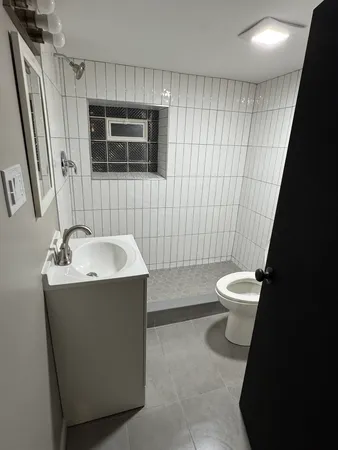 a bathroom with a sink toilet and shower