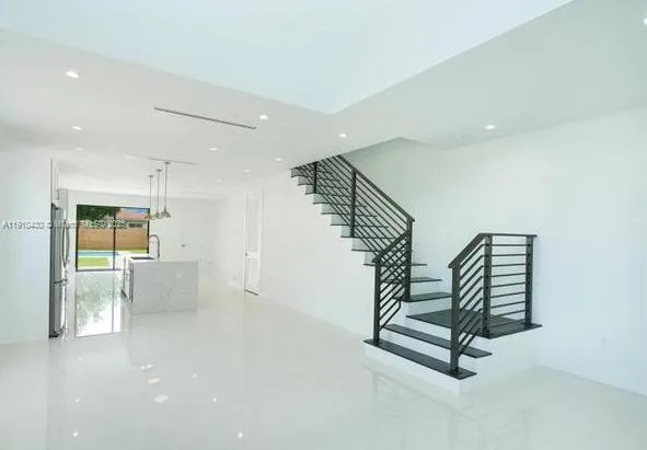 a kitchen that has a lot of cabinets and wooden floor