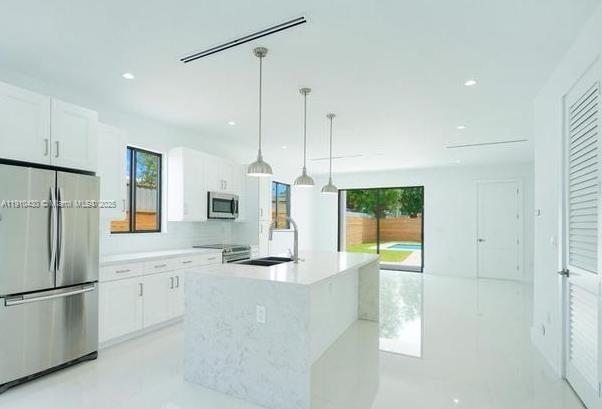 3024 Southwest 16th Terrace, Unit 3024 Miami, FL 33145 - Photo 6 of 16 a kitchen with stainless steel appliances granite countertop a refrigerator a sink and a stove