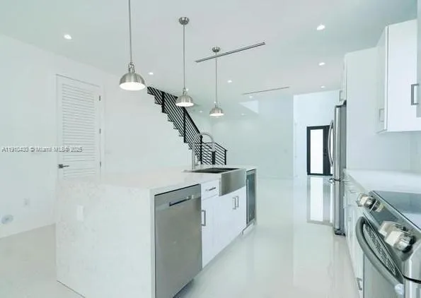 a bathroom with a granite countertop toilet sink and mirror