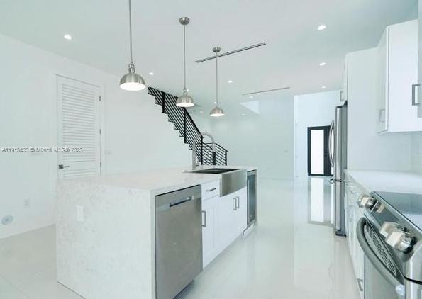3024 Southwest 16th Terrace, Unit 3024 Miami, FL 33145 - Photo 7 of 16 a kitchen that has a lot of cabinets and wooden floor