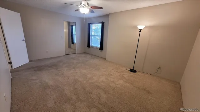 a view of a room with chandelier fan and windows