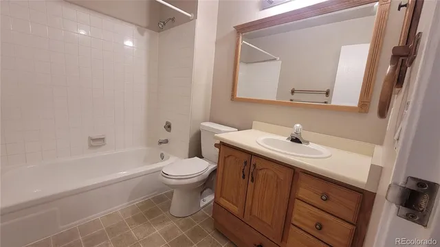 a bathroom with a sink toilet vanity and shower