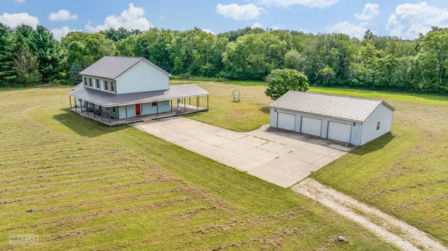 a view of a swimming pool with a yard and large tree