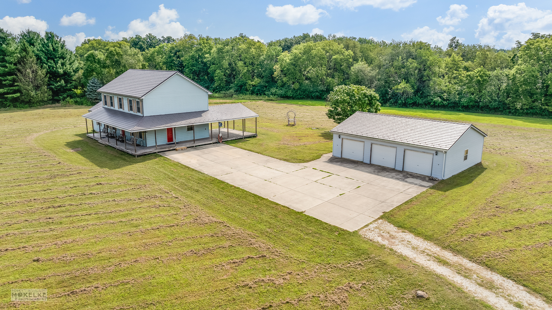 a view of a swimming pool with a yard and large tree