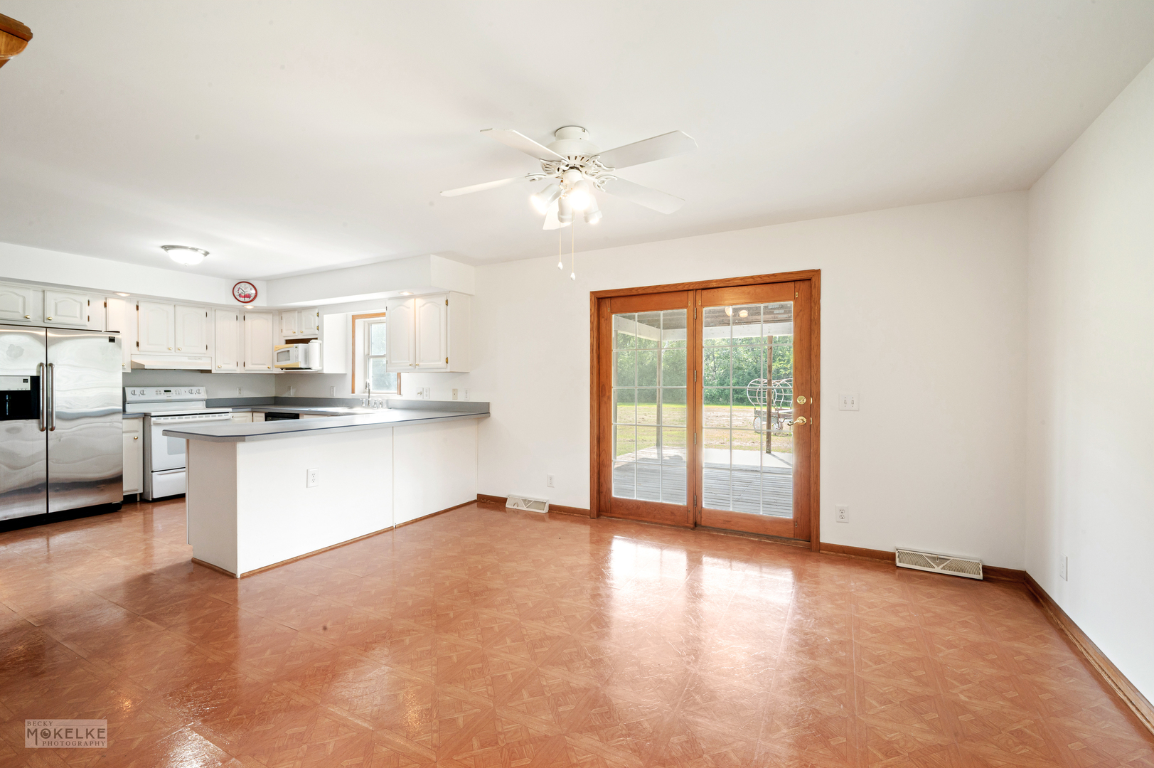 8124 A Finnie Road Newark, IL 60541 - Photo 13 of 33 a view of a kitchen with kitchen island wooden floors appliances and a fireplace