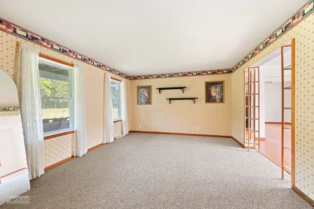 a view of a big room with windows and refrigerator