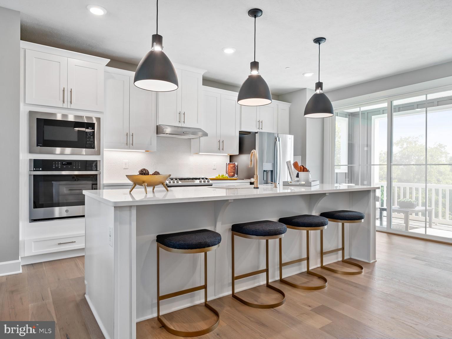1765 Mill Branch Drive Laurel, MD 20708 - Photo 11 of 12 a kitchen with stainless steel appliances granite countertop a stove a refrigerator and a wooden floor