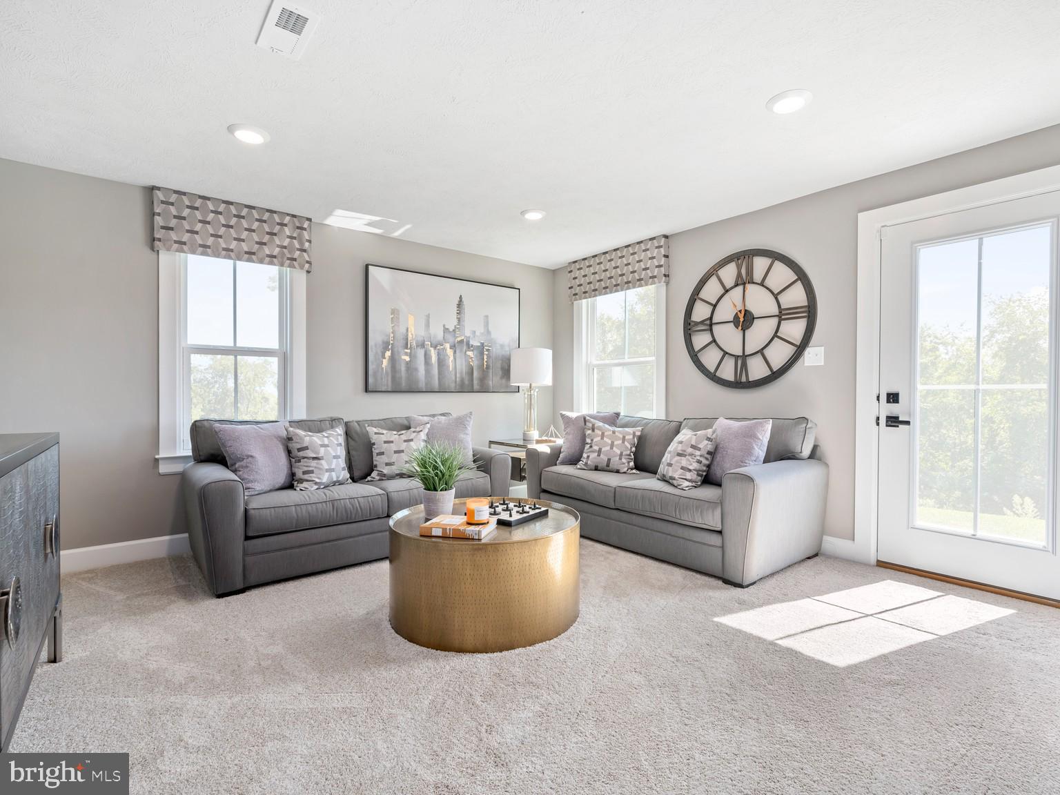 1765 Mill Branch Drive Laurel, MD 20708 - Photo 9 of 12 a living room with furniture a wall clock and a window