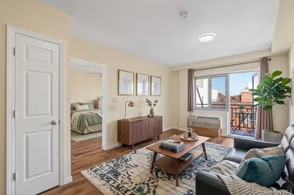 a bedroom with bed and wooden floor