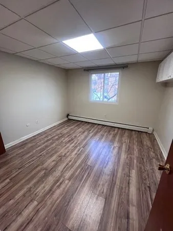 a view of a room with wooden floor