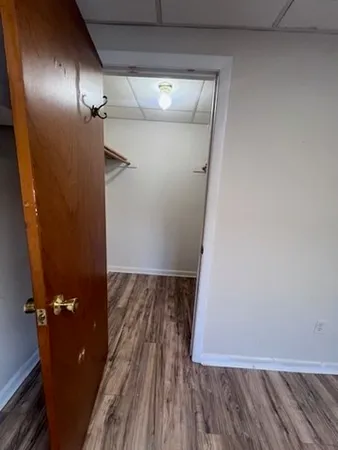 a view of a room with wooden floor and bench