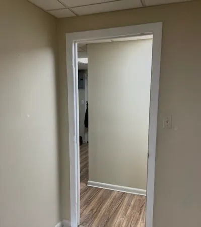 a view of a hallway with wooden floor and staircase