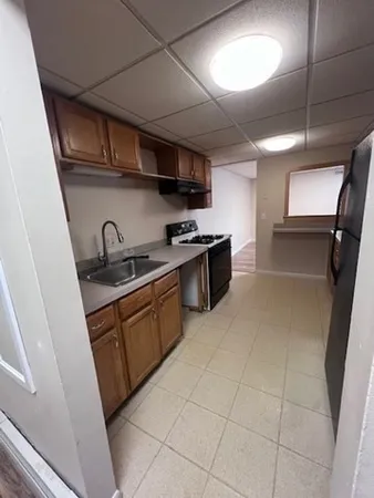 a kitchen with stainless steel appliances a refrigerator and a stove
