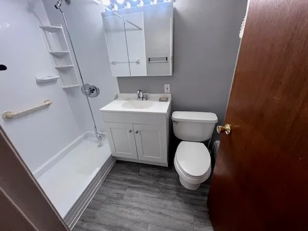a bathroom with a shower sink and mirror