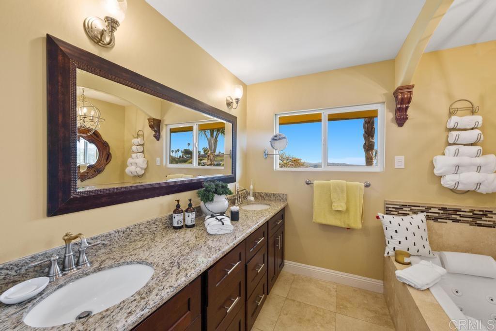 1131 Rainbow Valley Boulevard Fallbrook, CA 92028 - Photo 18 of 73 a bathroom with a granite countertop sink mirror and vanity