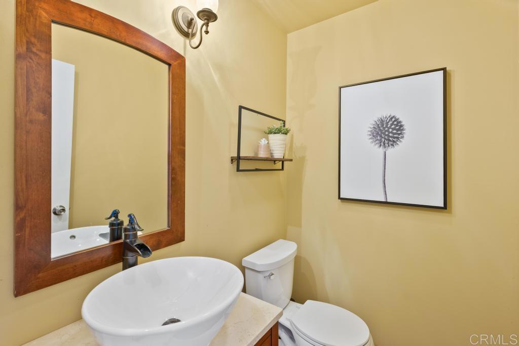 1131 Rainbow Valley Boulevard Fallbrook, CA 92028 - Photo 20 of 73 a bathroom with a toilet and a sink