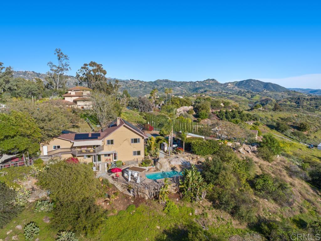 1131 Rainbow Valley Boulevard Fallbrook, CA 92028 - Photo 26 of 73 a view of a house with a mountain and a forest