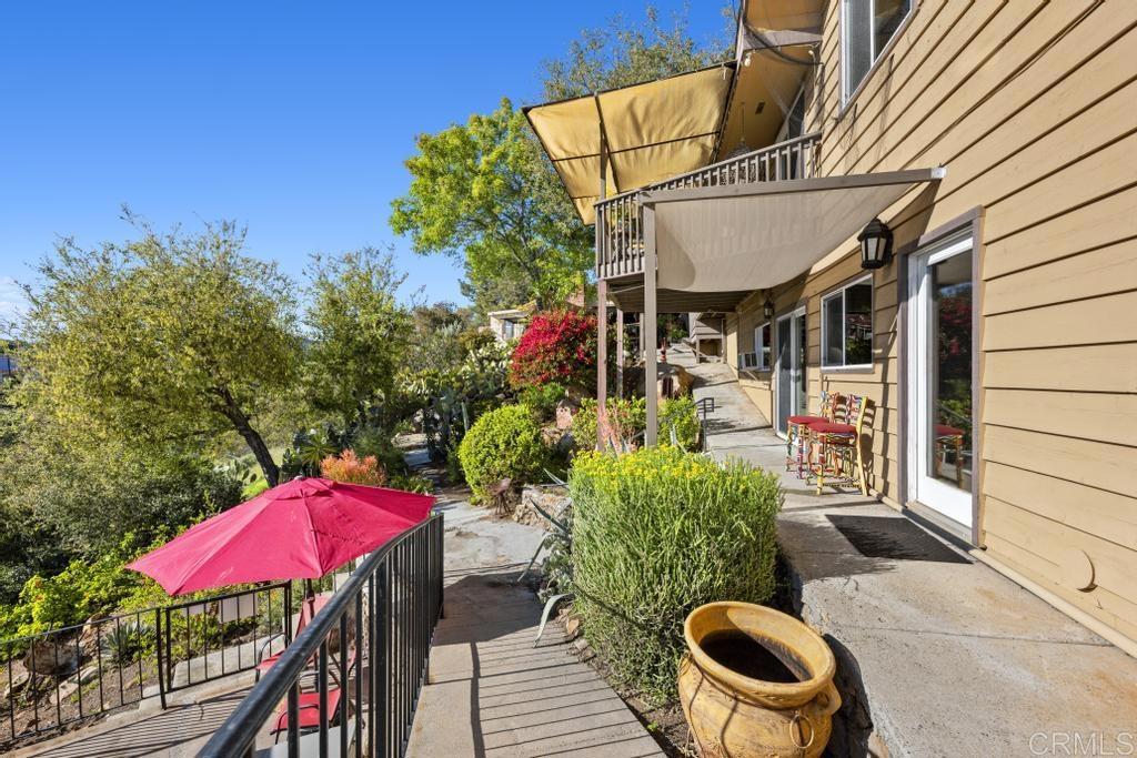 1131 Rainbow Valley Boulevard Fallbrook, CA 92028 - Photo 42 of 73 a view of a patio with table and chairs potted plants