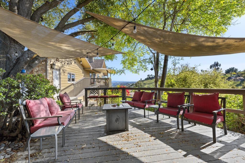 1131 Rainbow Valley Boulevard Fallbrook, CA 92028 - Photo 47 of 73 an outdoor sitting area with furniture and wooden floor