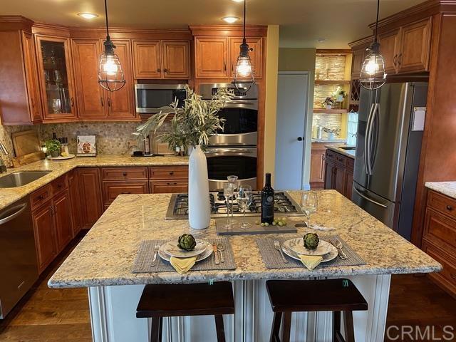 1131 Rainbow Valley Boulevard Fallbrook, CA 92028 - Photo 5 of 73 a kitchen with cabinets and refrigerator