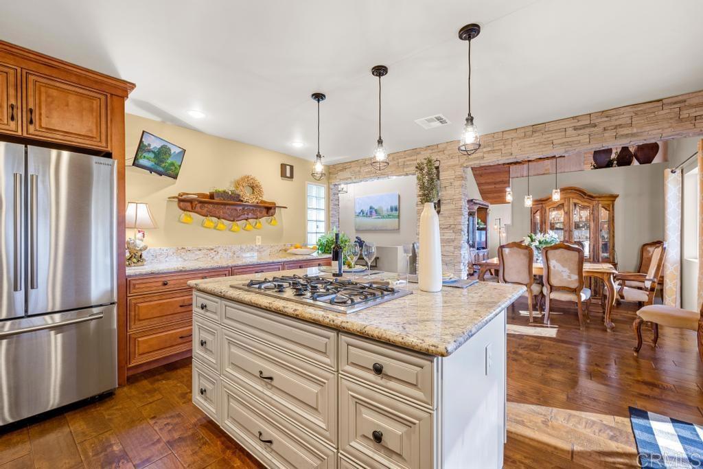 1131 Rainbow Valley Boulevard Fallbrook, CA 92028 - Photo 7 of 73 a kitchen with stainless steel appliances granite countertop a refrigerator a oven and a wooden floors