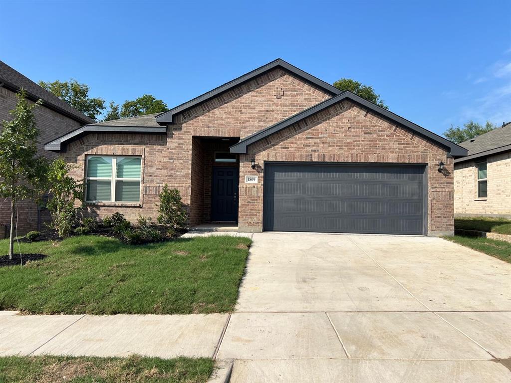 1809 Osage Trail Mesquite, TX 75149 - Photo 1 of 18 a front view of a house with a yard and garage