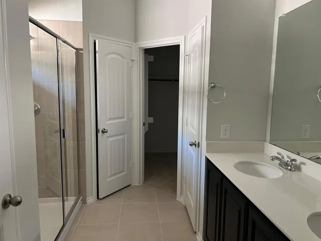 a bathroom with a double vanity sink and mirror