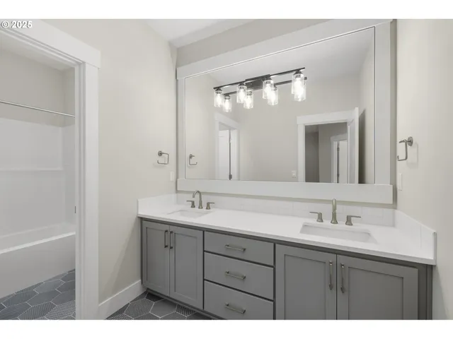 a bathroom with a sink vanity and a mirror