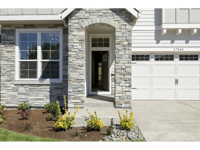 a front view of a building with a garden