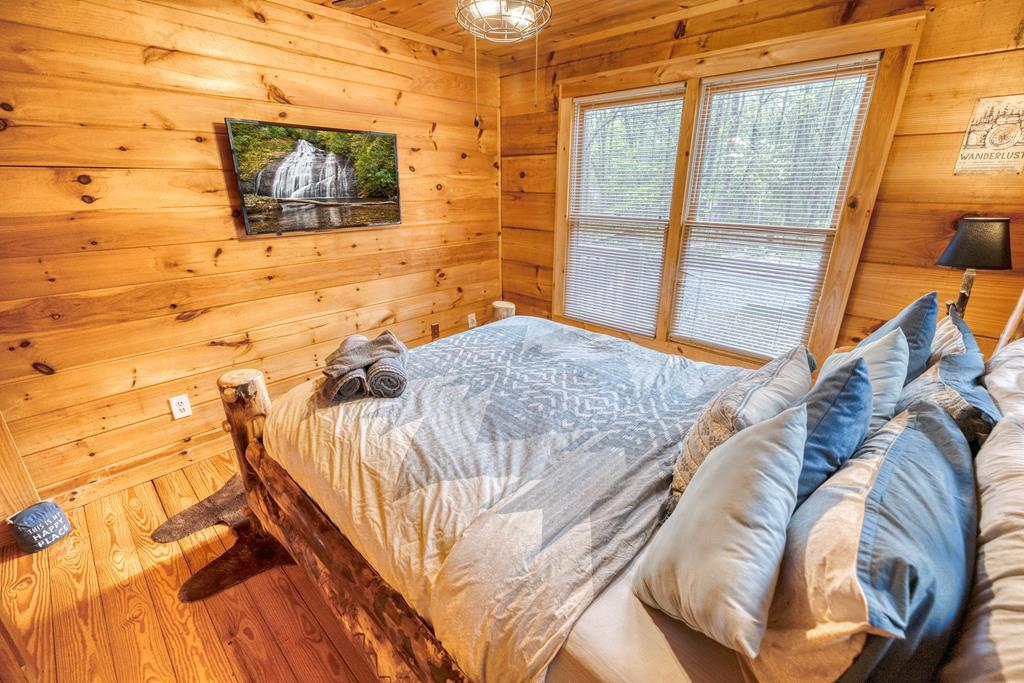 31 The Kings Court Cherry Log, GA 30522 - Photo 22 of 50 a bedroom with a bed and a flat screen tv