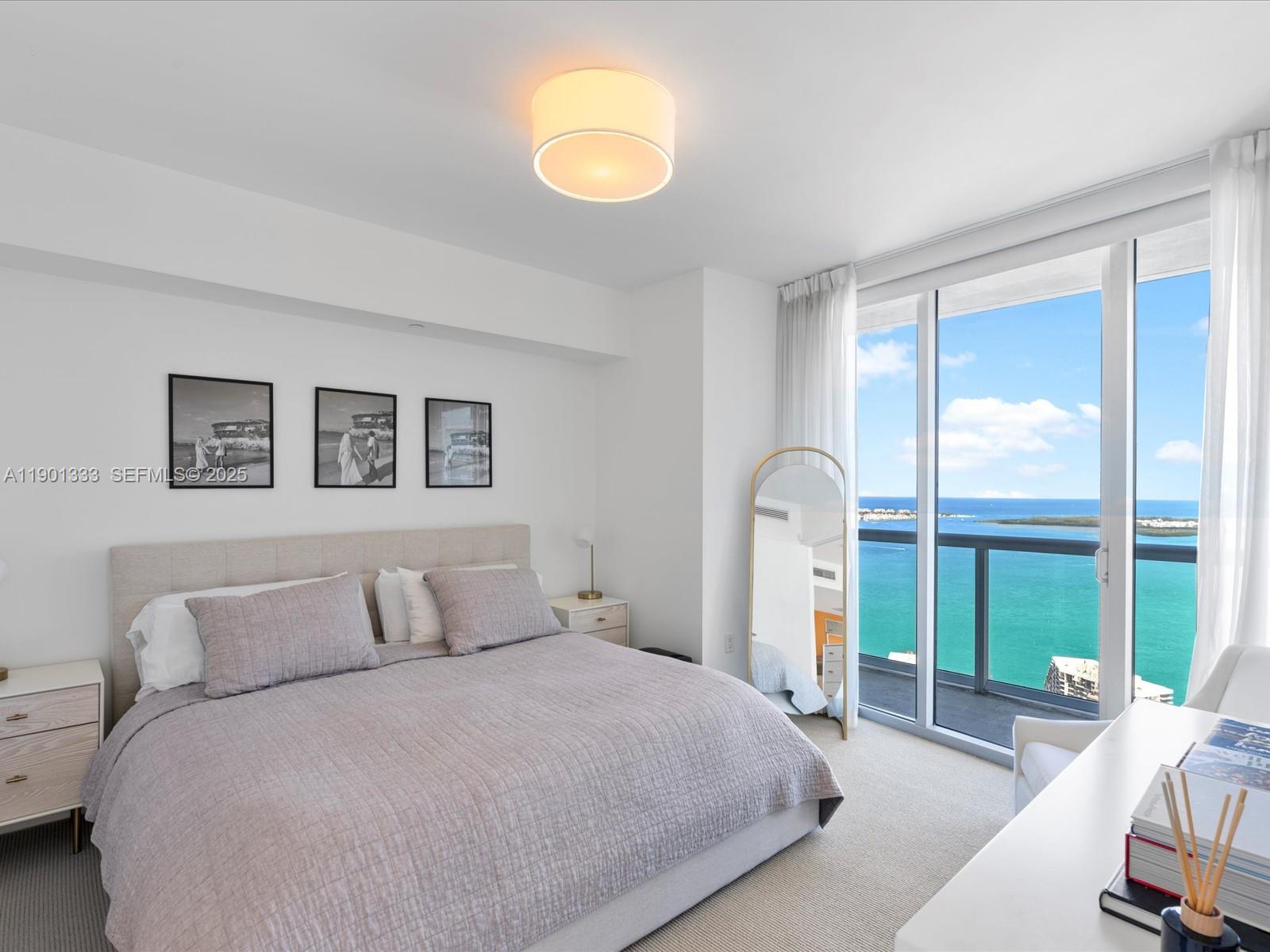 475 Brickell Avenue, Unit 5507 Miami, FL 33131 - Photo 11 of 21 a bedroom with a bed and a large window