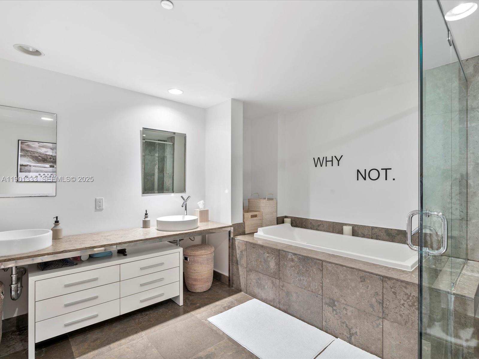 475 Brickell Avenue, Unit 5507 Miami, FL 33131 - Photo 19 of 21 a spacious bathroom with a double vanity sink a mirror and a bathtub