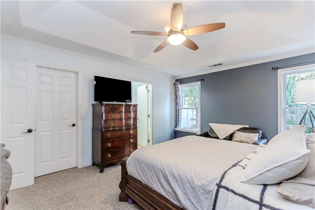 2790 Alcovy River View Dacula, GA 30019 - Photo 15 of 23 a bedroom with a large bed and a tv