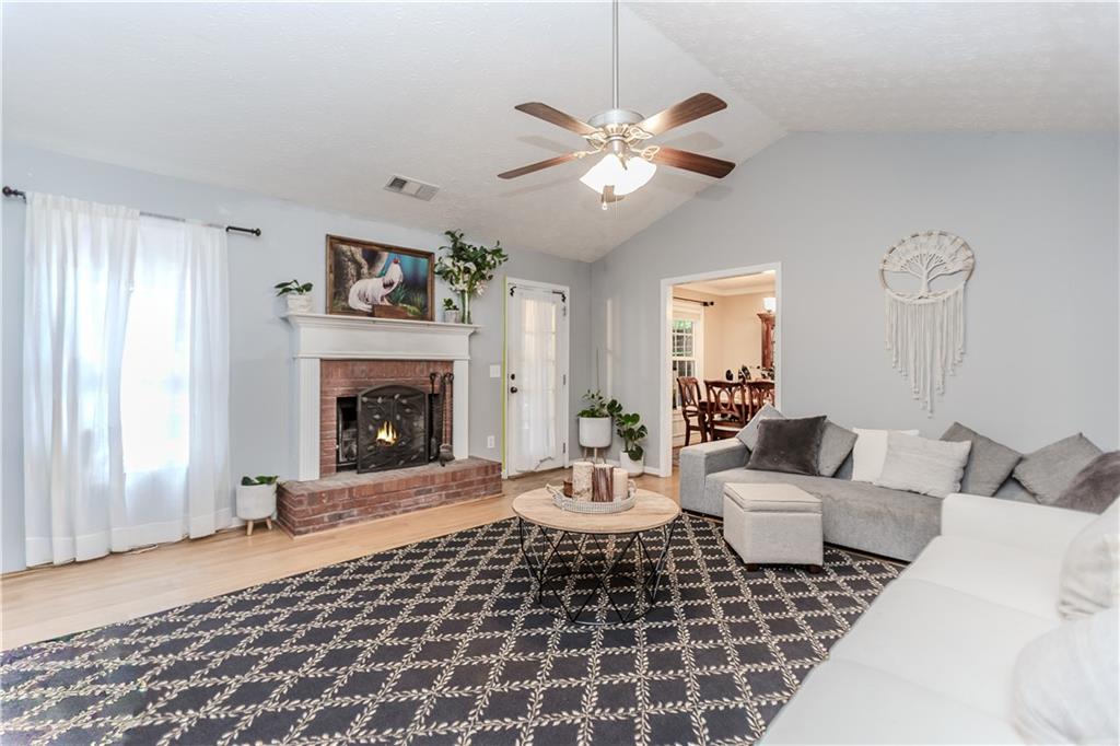 2790 Alcovy River View Dacula, GA 30019 - Photo 4 of 23 a living room with furniture a window and a fireplace