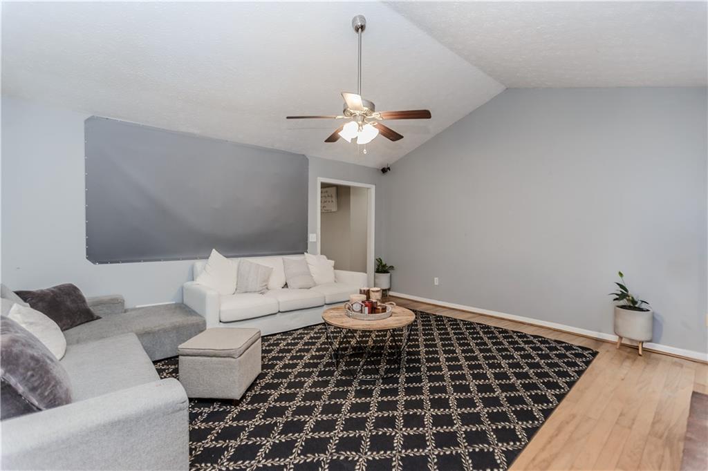 2790 Alcovy River View Dacula, GA 30019 - Photo 5 of 23 a living room with furniture and a chandelier